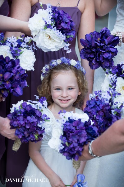 Flower girl surrounded by bouquets 